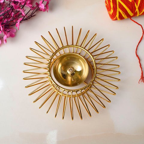 Gold-toned decorative Akhand Sun Shape Brass Diya featuring a radiant Surya (sun) motif and eternal flame chamber, ideal for spiritual lighting and festive décor. India’s Largest Pooja Accessories Brand – www.satvikstore.in