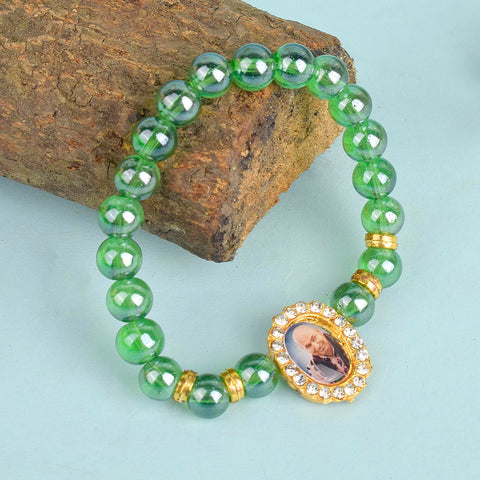 Green Shiny Beads Single Layer Guruji Swaroop Bracelet featuring dazzling green beads and Jai Guruji Swaroop – perfect for minimalist spiritual wear, meditation, and gifting. India’s Largest Pooja Accessories Brand – www.satvikstore.in